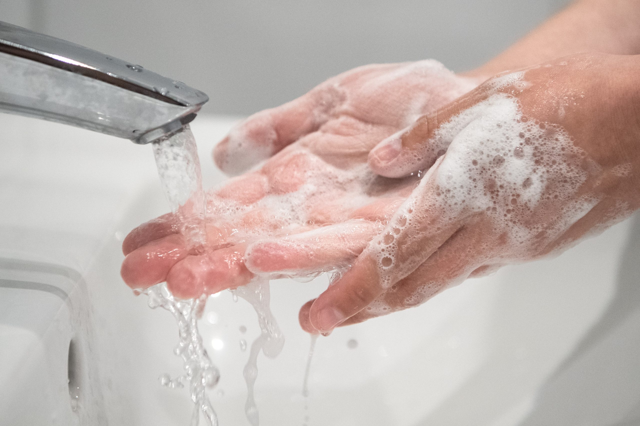 Frau wäscht ihre Hände mit Seife.