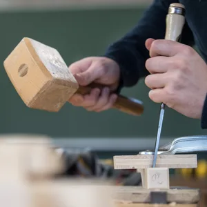 Ein Tischler in Ausbildung bei der Arbeit