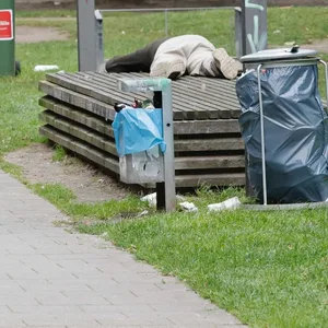 Ein Obdachloser schläft auf einer Bank. So soll auch der Mann genächtigt haben, dessen Schlafsack angezündet wurde.
