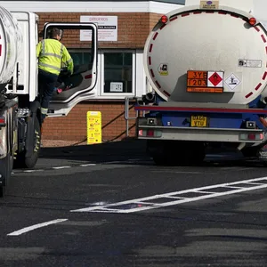 Kraftstofftankwagen stehen vor der Einfahrt der Petroineos-Raffinerie in Grangemouth auf einer Straße. Die britische Regierung ist unter enormen Druck, den Lkw-Fahrermangel zu beheben.