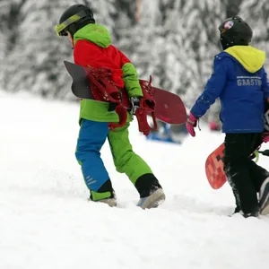 Junge Wintersporttouristen sind am Wurmberg zu Fuß an einem Hang unterwegs. (Archivfoto)