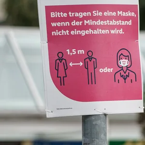 Auf einem Schild in der Kieler Innenstadt wird um das Tragen einer Maske gebeten.