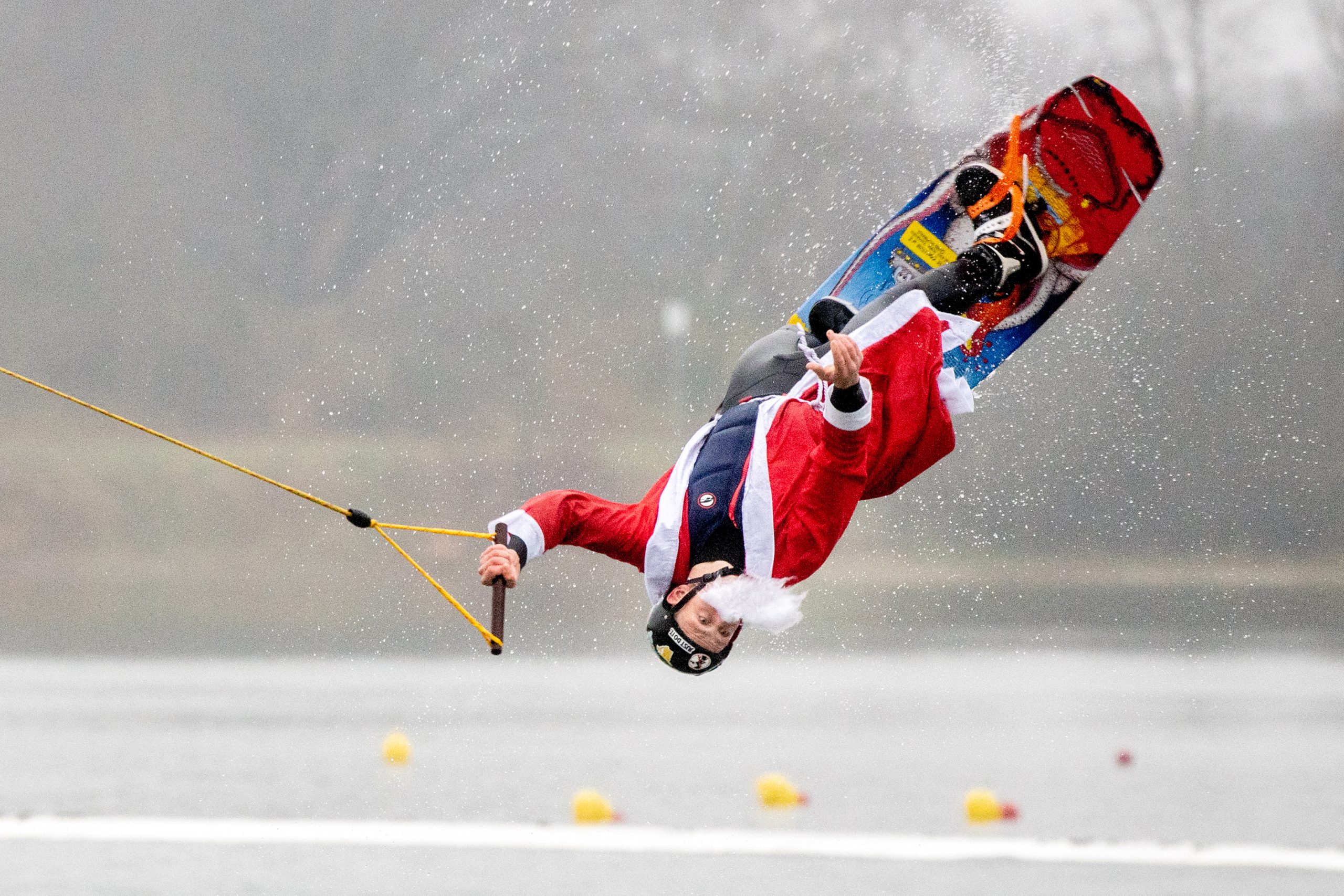 Teilnehmer Wilke springt, verkleidet als Weihnachtsmann, mit seinem Wakeboard über eine Rampe im Badesee des Ortsteils Tannenhausen.
