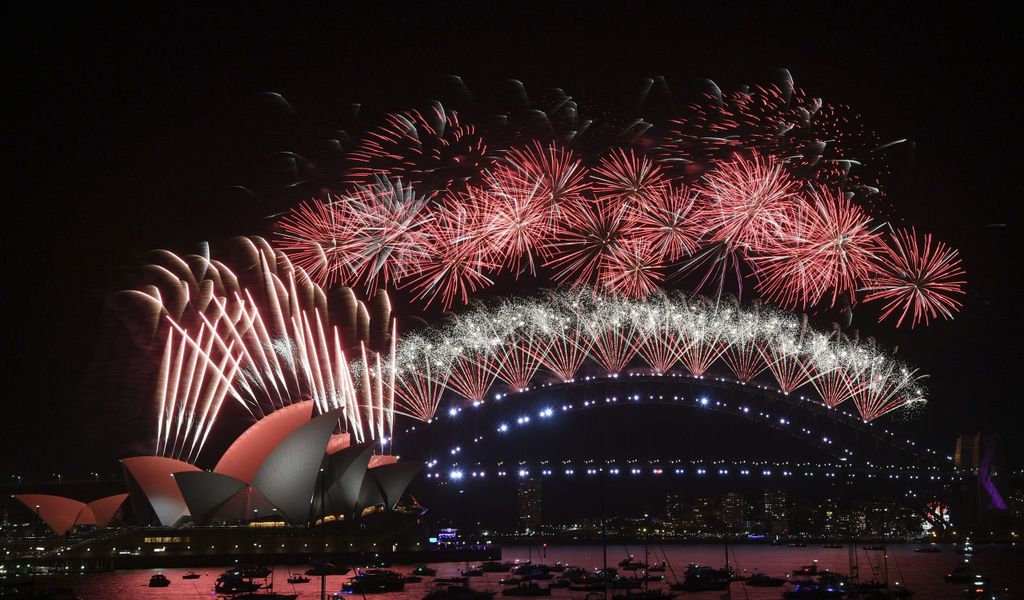 Feuerwerkskörper explodieren über dem Opernhaus und der Harbour Bridge von Sydney während der Silvesterfeierlichkeiten.