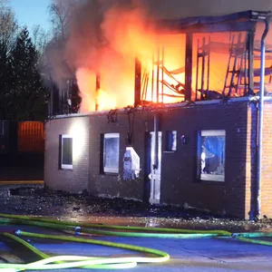 Flammen treten aus einem Gebäude, das obere Stockwerk ist zerstört