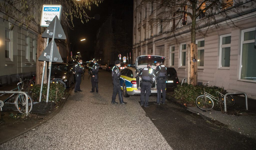 Hamburger Polizisten stehen vor dem Wohnhaus und bewaffnen sich.