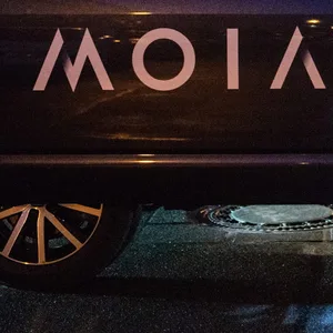 Ein Fahrgast des Ridesharing Anbieters MOIA steigt nach der Fahrt aus dem VW-Bus aus.