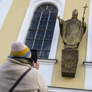 Eine Figur des emeritierten Papstes Benedikt XVI. hängt an einer Fassade am Kapellenplatz im Zentrum von Altötting.