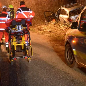 Rettungskräfte und die Polizei stehen nach dem Unfall auf der Straße.