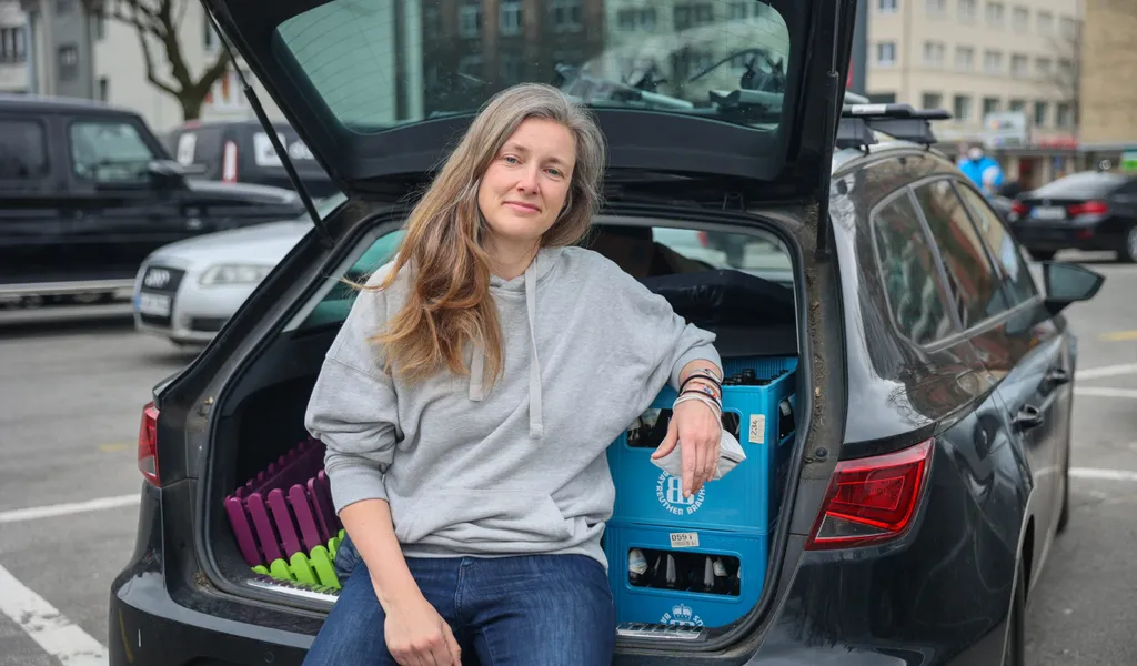 Lena Schwarzer lehnt an den Getränkekisten in ihrem Kofferraum.