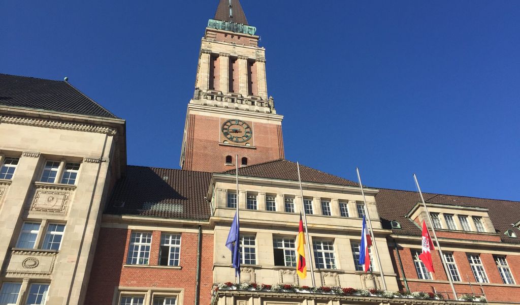 Die Fahnen vor dem Kieler Rathaus hängen auf Halbmast.