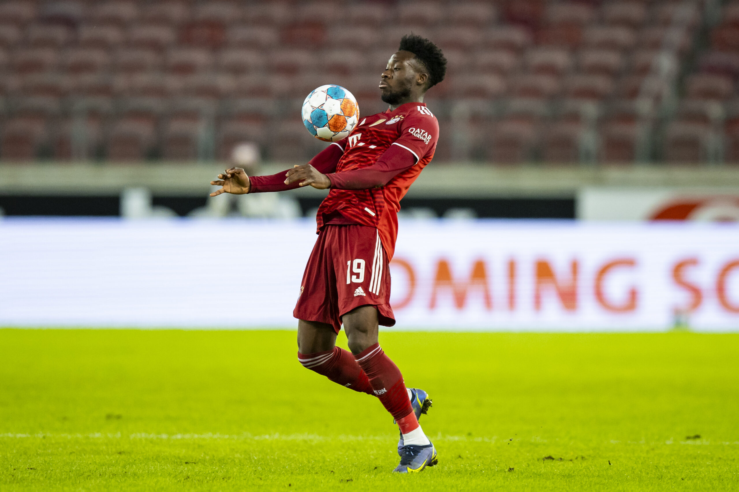 Bayern Linksverteidiger Alphonso Davies nimmt den Ball mit der Brust an