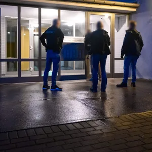 Polizeibeamte vor einem Wohnhaus in Hamburg. Es gab Durchsuchungen in Bezug auf abgegebene Hass-Postings.
