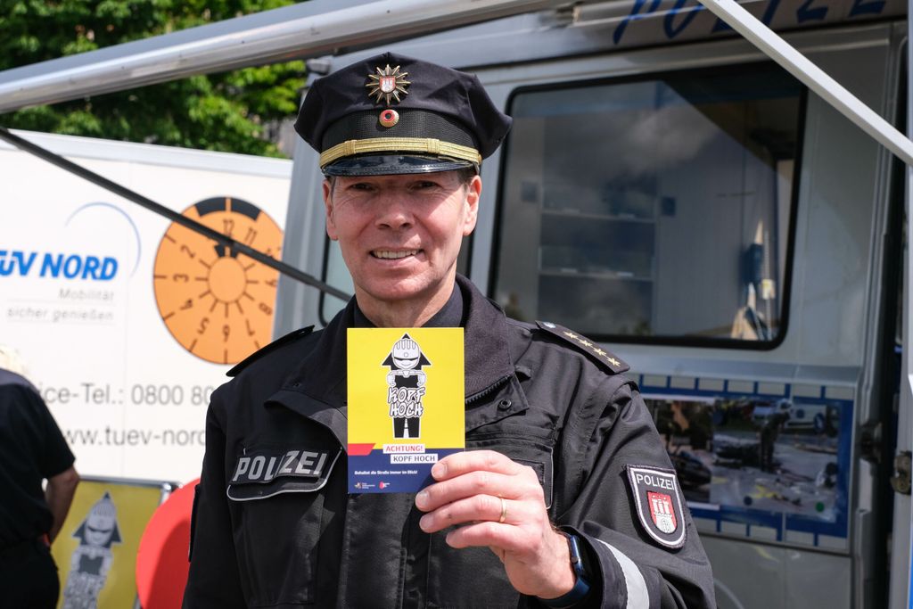 Ulf Schröder, Hamburgs oberster Verkehrspolizist, mit einem Flyer der neuen Kampagne „Kopf hoch“
