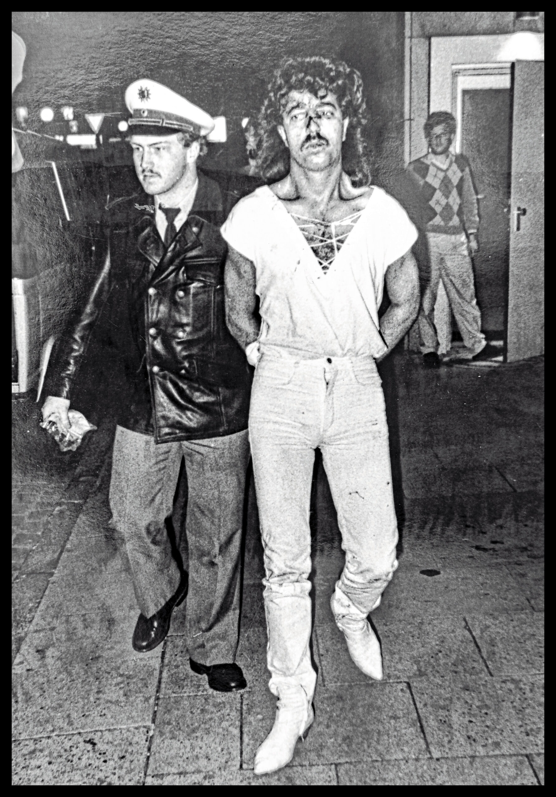 Was für ein Outfit! Der Zuhälter Sadettin T. (25) wird nach den tödlichen Schüssen von einem Polizisten abgeführt und zur Mordkommission am Berliner Tor gebracht.