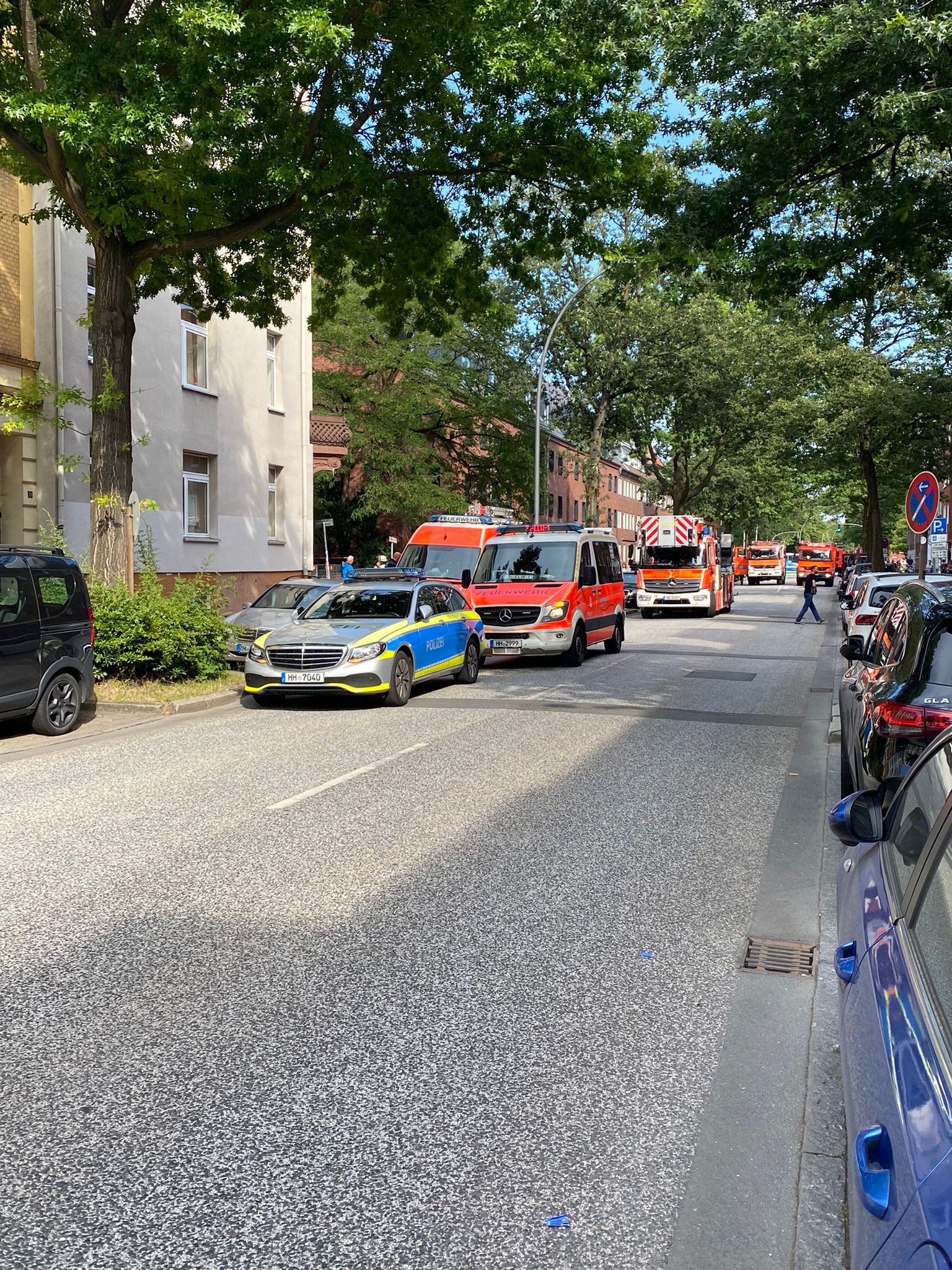 Polizei- und Feuerwehr-Fahrzeuge parken vor dem Wohnhaus in Heimfeld.