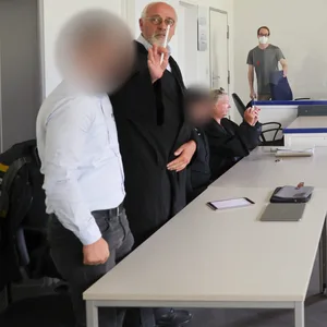 Die zwei Angeklagten (l. und 3 v.l.) mit ihren Anwälten im Gerichtssaal.