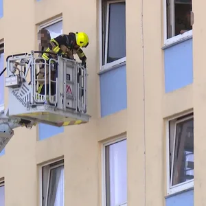 Über eine Drehleiter wird einer der Bewohner von der Feuerwehr gerettet.