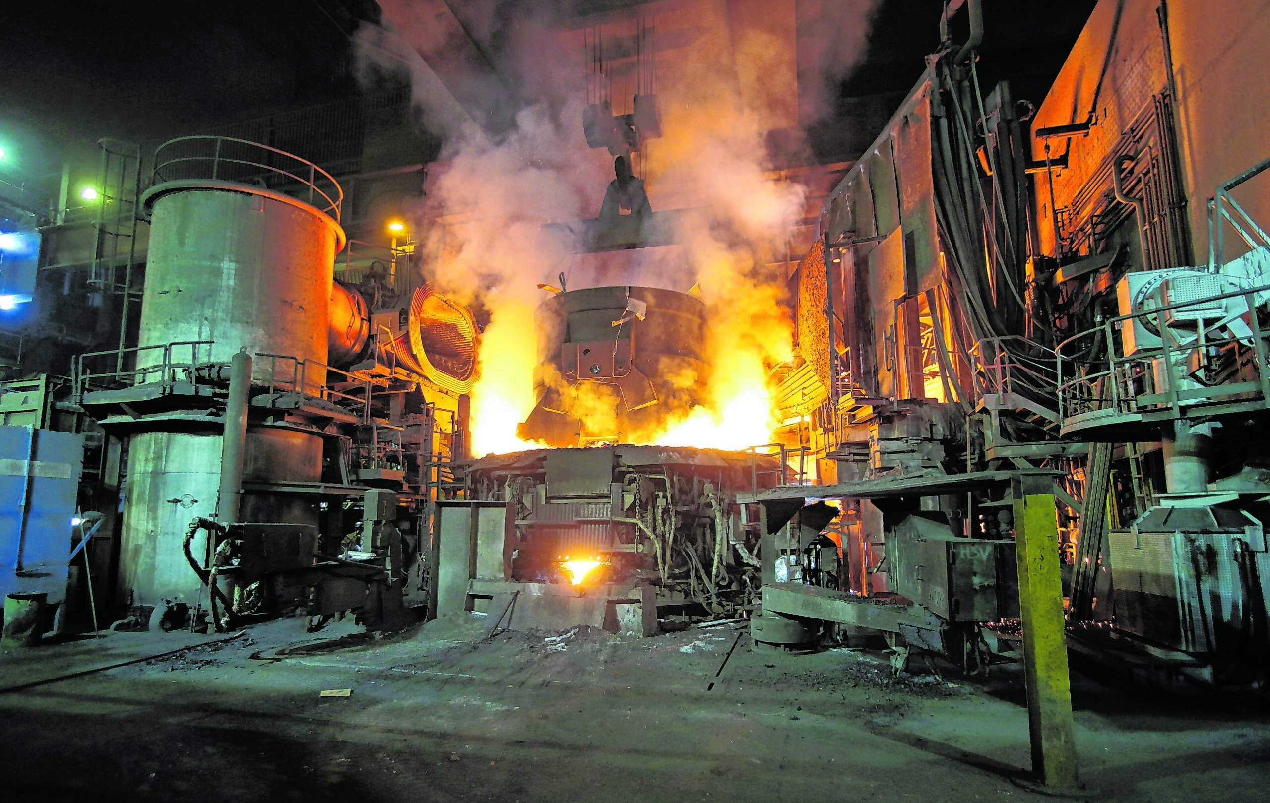 Ein Transportkorb mit Schrott wird am 25.03.2013 in den Lichtbogenofen in der Stahlwerkshalle von ArcelorMittal in Hamburg gekippt. Der weltgrößte Stahlkonzern ArcelorMittal nahm am Montag einen neuen Pfannenofen in seinem Werk in Hamburg in Betrieb.