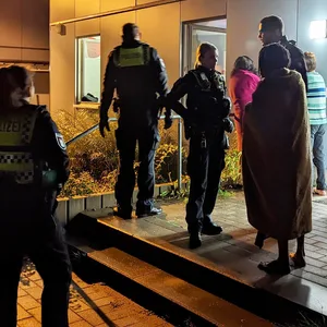 Einsatzkräfte der Polizei und Feuerwehr vor dem Haus in Rahlstedt.