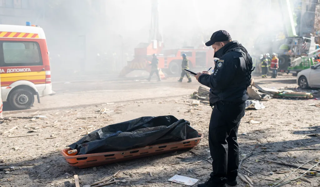 Ein Polizist steht neben der Leiche eines Mannes, der durch eine Drohne getötet wurde.