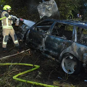 Feuerwehrmänner löschen den brennenden Mercedes. Der Fahrer soll alkoholisiert gewesen sein.