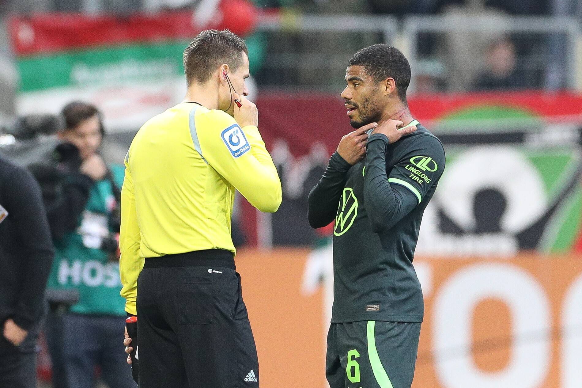 Wolfsburg-Spieler Paulo Octavio zeigt dem Schiedsrichterassistenten die Kratzspuren am Hals.