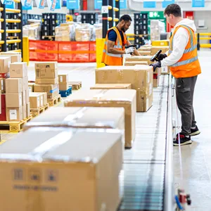 Ein Mitarbeiter steht am Paketband bei Versandriese Amazon