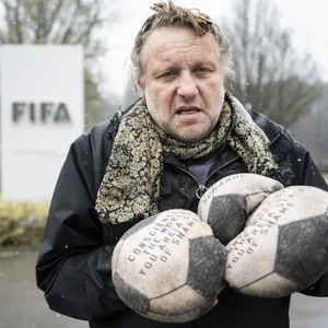 Volker-Johannes Trieb bei seiner Protestaktion am Tag der WM-Auslosung. Er hält einige der genähten Bälle in der Hand