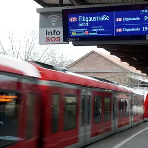 S-Bahn fährt auf Bahnsteig ein.