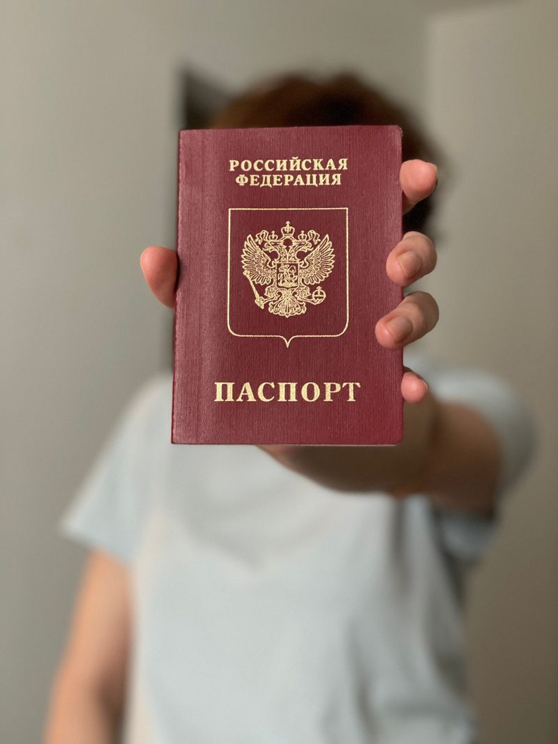 Svetlana (38), Lehrerin aus Eimsbüttel. Sie stammt aus Moskau. Aus Angst erkannt zu werden, verdeckt sie mit dem Pass ihr Gesicht.