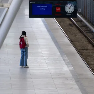 Eine Frau wartet an einer U-Bahn-Haltestelle.