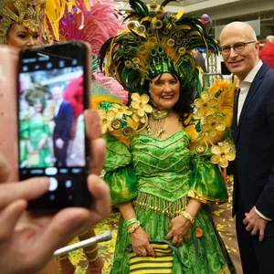 Peter Tschentscher wird mit einem Smartphone fotografiert, neben ihm eine Samba-Tänzerin (Symbolbild)