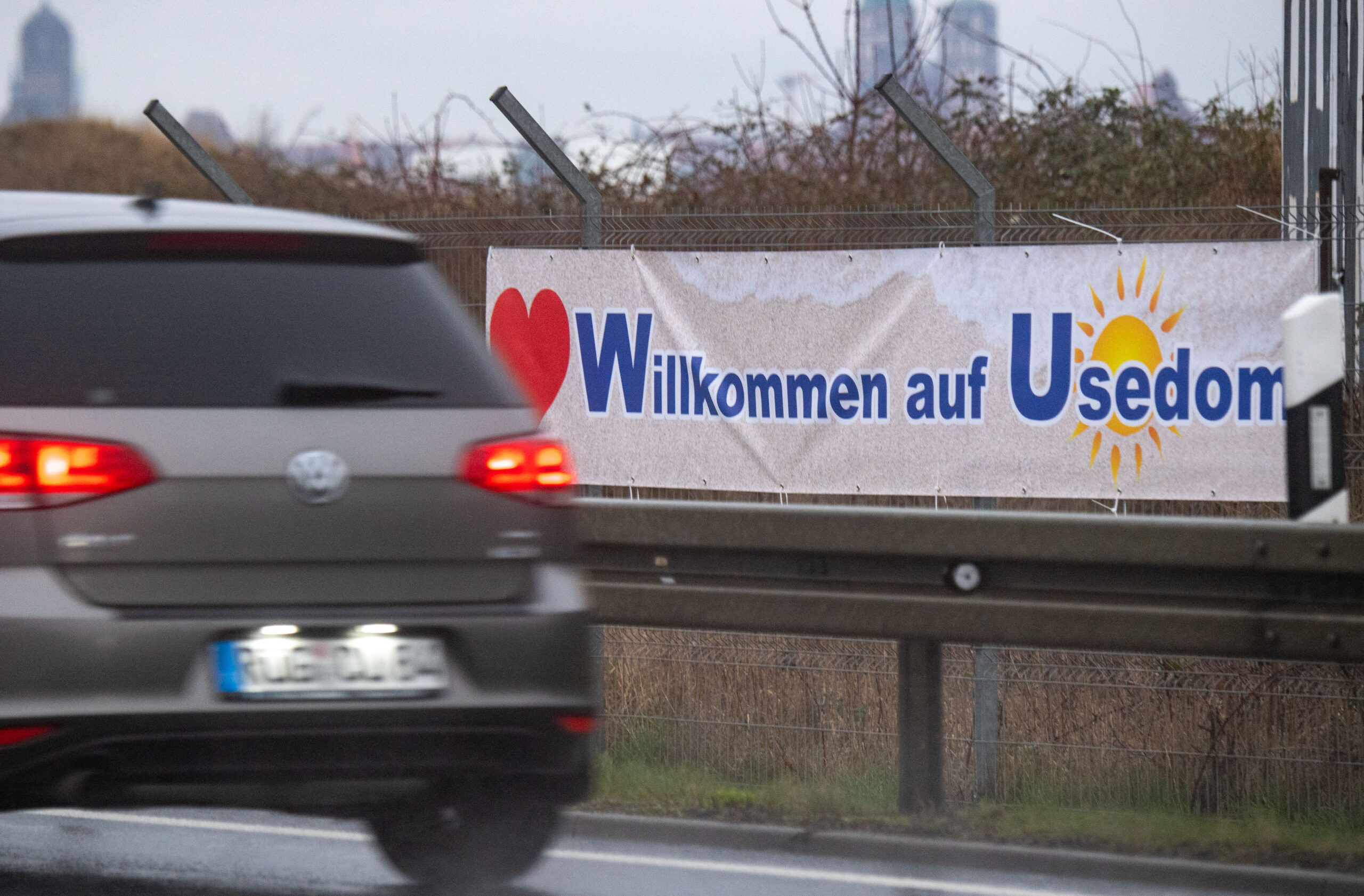 Ein Plakat mit dem Schriftzug "Willkommen auf Usedom" hängt an der B 96 auf der Insel Rügen.
