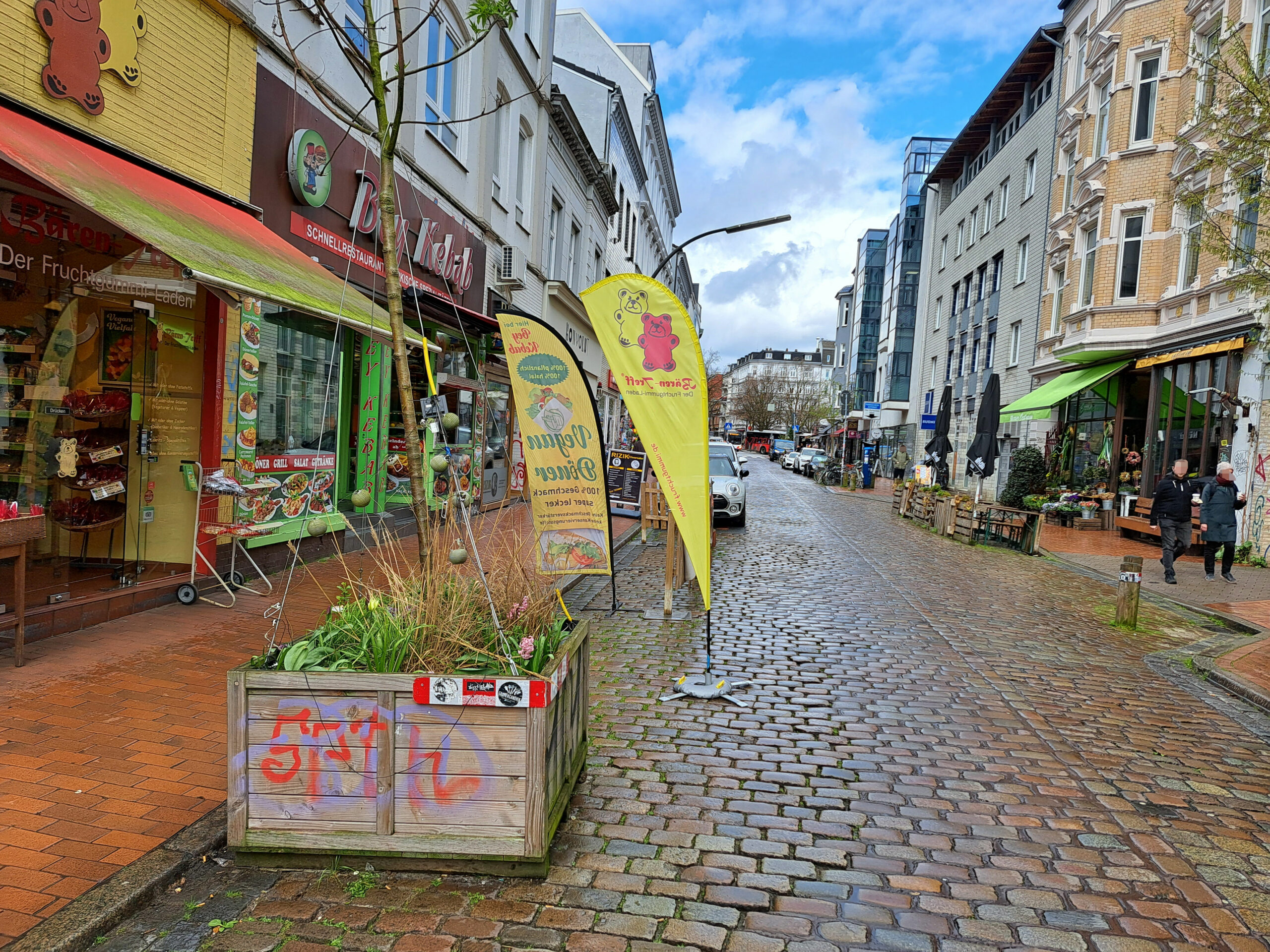 In der Ottenser Hauptstraße stehen bunt bepflanzte Kübel.