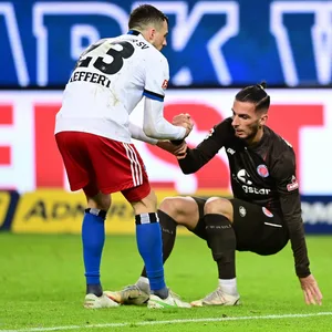 Jonas Meffert hilft Leart Paqarada beim Aufstehen