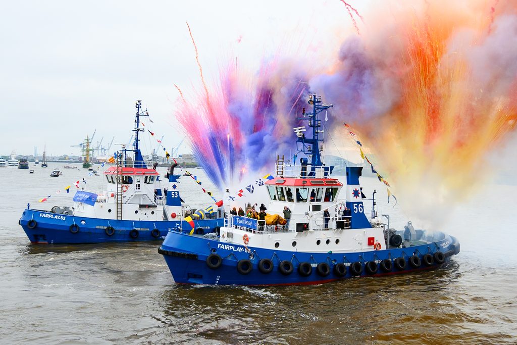 Bunte Pyrotechnik wird zum Ende des traditionellen Schlepperballetts an Bord der Schlepper auf der Elbe vor der Elbphilharmonie gezündet.