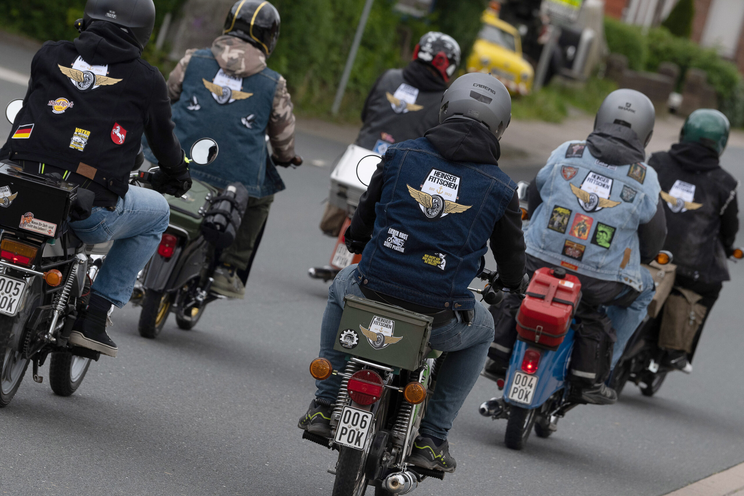 Sechs Mopedfahrer von hinten
