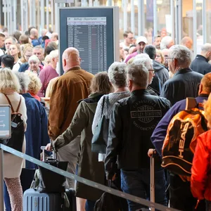 Reisende warten in langen Schlangen vor der Sicherheitskontrolle am Flughafen Hamburg auf die Abfertigung.