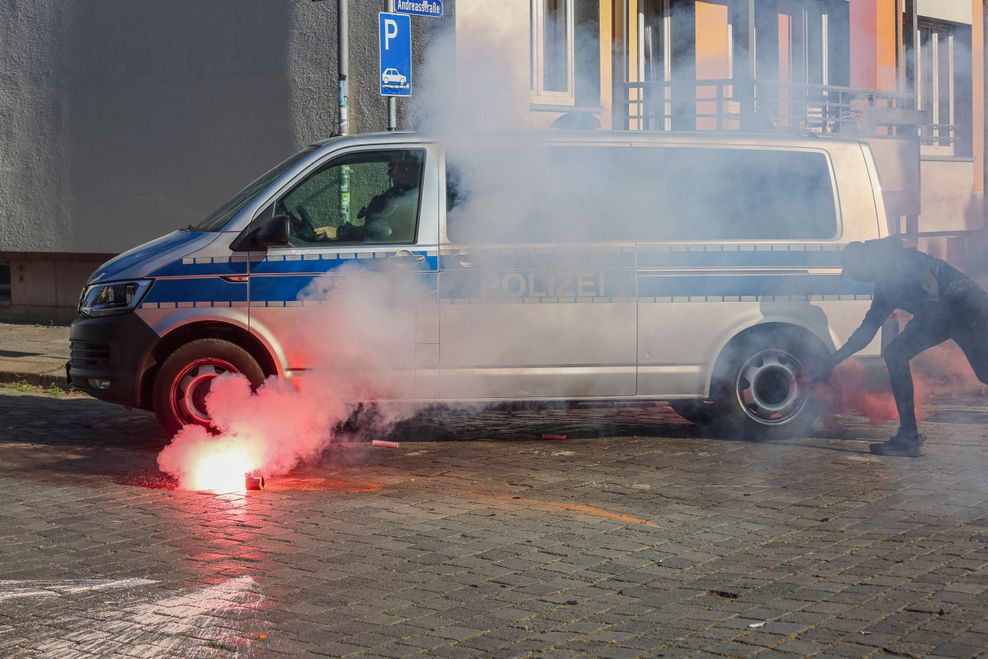 Ein Demonstrant versucht, ein Polizeiauto in Brand zu setzen.