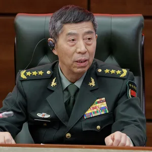 Verteidigungsminister Li Shangfu sitzt in Uniform bei einem Treffen auf einem Stuhl.