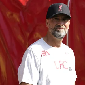 Jürgen Klopp im weißen Liverpool-Tshirt und schwarzer Liverpool-Cup.