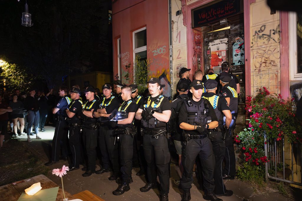 Polizisten sichern den Einsatz der Kollegen ab, die versuchen, ins Innere des Lokals zu gelangen.