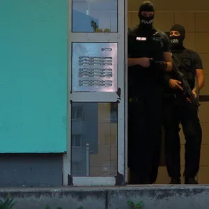 Bewaffnete und maskierte Bundespolizisten im Haus des Verdächtigen.