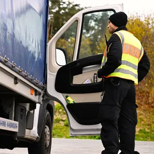 Ein Polizist kontrolliert einen Lkw (Symbolbild).