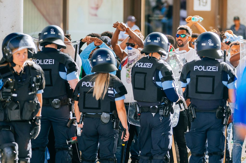 Eine Gruppe von Menschen wird nach Ausschreitungen bei einer Eritrea-Veranstaltung von Polizeikräften eingekesselt.