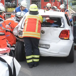 Einsatzkräfte versorgen eine verletzte Person nach dem Unfall auf der A24.