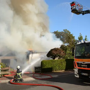 Feuerwehrleute löschen den Brand in der Flüchtlingsunterkunft in Trittau.