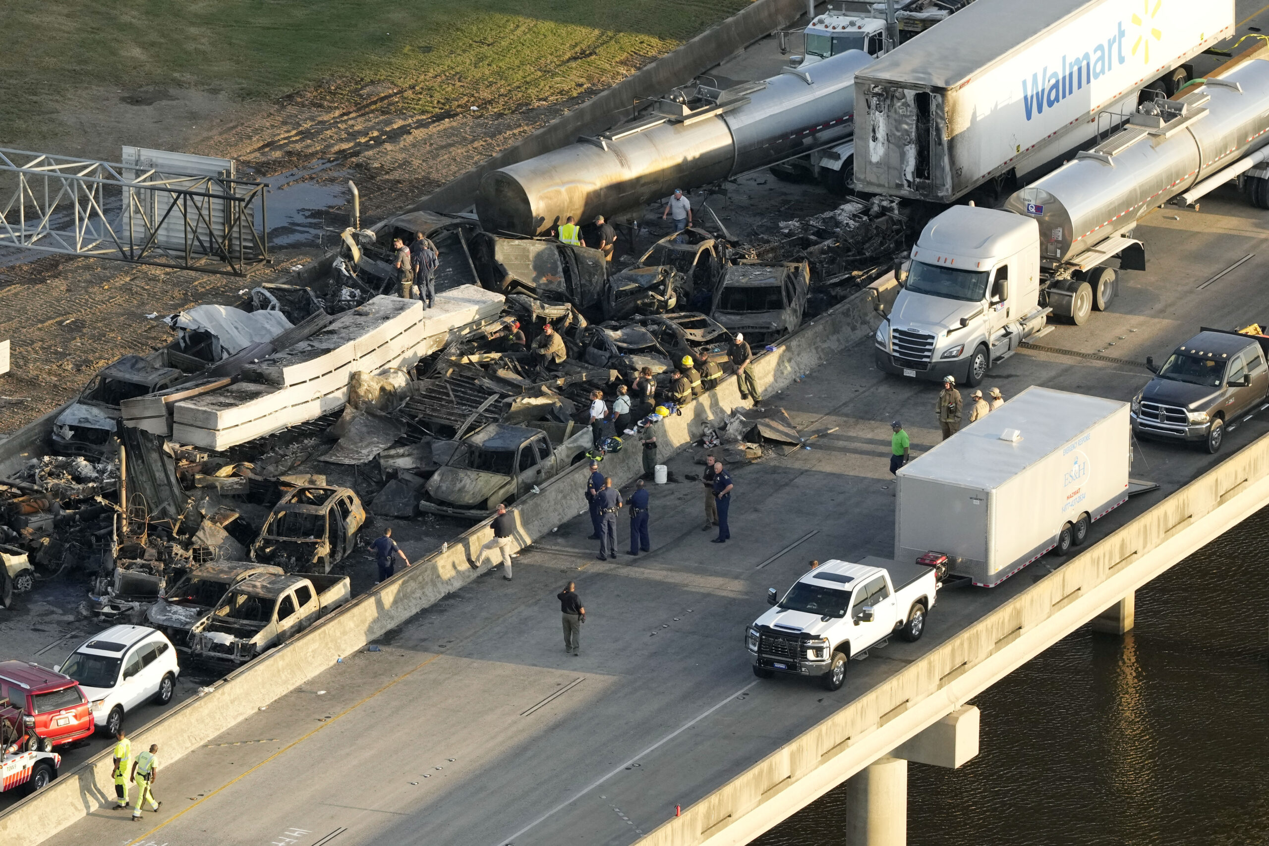 Auf diesem Luftbild sieht man Einsatzkräfte bei ausgebrannten oder stark beschädigten Autowracks nach einer Massenkarambolage auf der Interstate 55 bei Manchac, Louisiana.