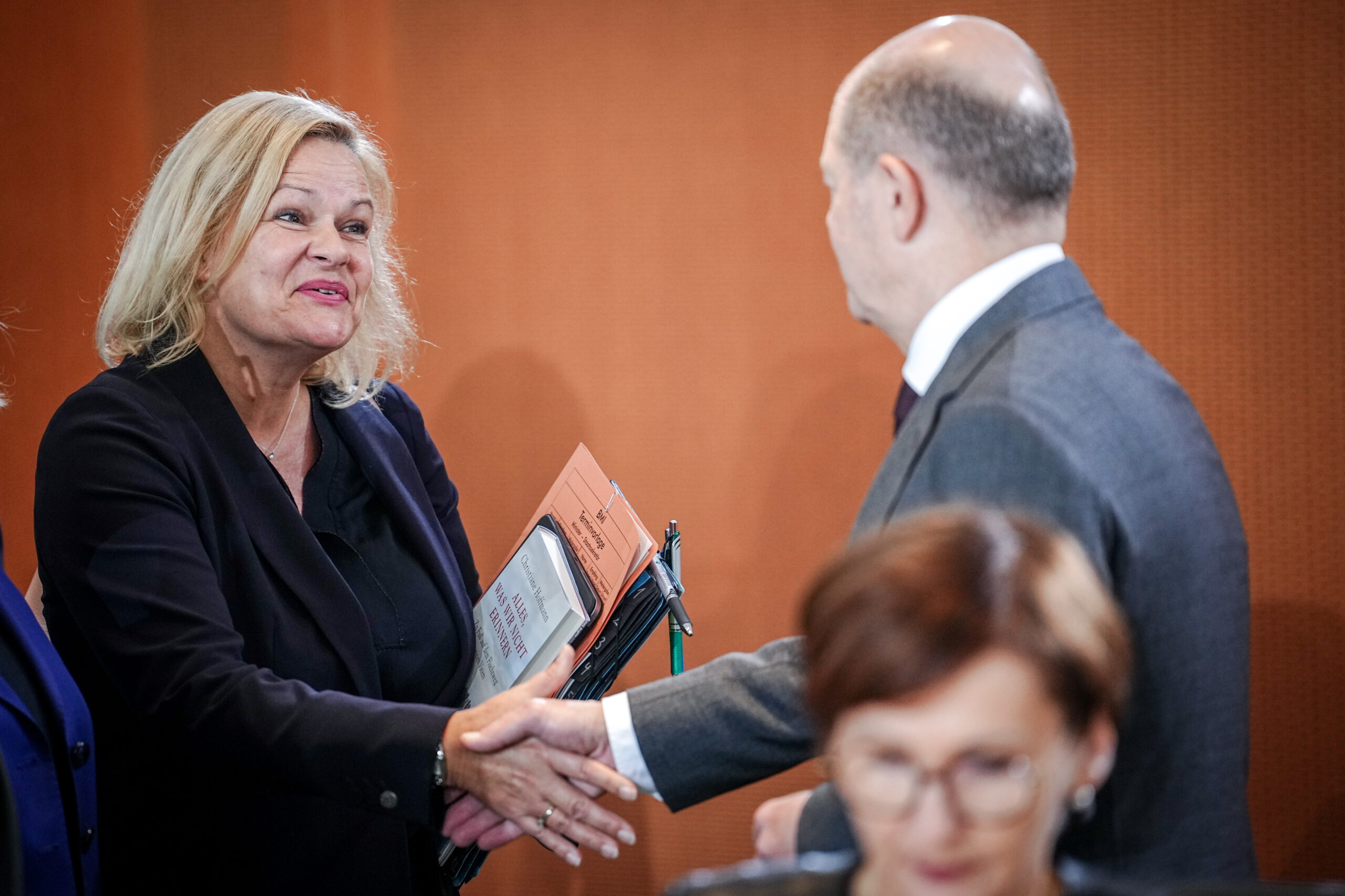 Nancy Faeser und Olaf Scholz (beide SPD) schütteln sich nach dem Kabinetts-beschluss erleichtert die Hände.